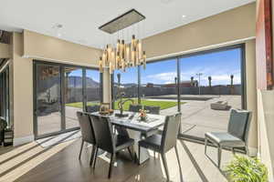 Sunroom featuring a chandelier and a mountain view