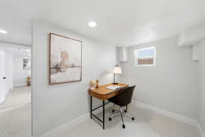 Office area featuring baseboards and a textured ceiling