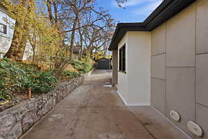 View of home's exterior with a detached garage, stucco siding, and an outbuilding