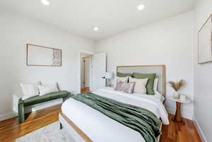 Bedroom with wood finished floors and recessed lighting