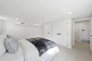 Bedroom featuring a closet, light carpet, and recessed lighting