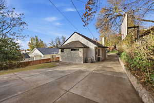 View of home's exterior featuring a shingled roof and stucco siding