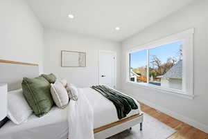 Bedroom with wood finished floors and recessed lighting