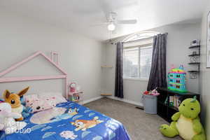 Bedroom featuring light colored carpet and a ceiling fan