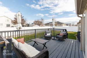 Wooden deck featuring a residential view and a fenced backyard