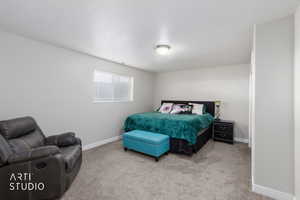 Bedroom with light carpet and baseboards