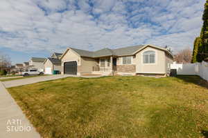 Ranch-style house with concrete driveway, stucco siding, a garage, and stone siding