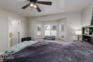 Carpeted bedroom featuring a ceiling fan and ensuite bath