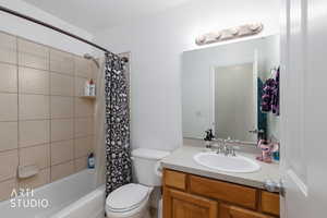 Full bathroom with shower / bath combo and vanity