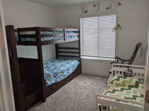 Bedroom with light carpet and baseboards