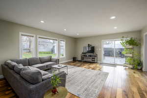 Living room featuring light wood-style floors and recessed lighting