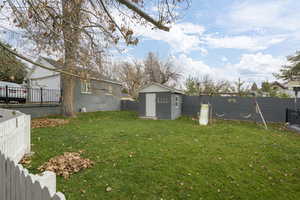 Fenced backyard with a storage unit