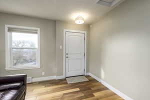 Entrance foyer featuring light wood-type flooring and a textured ceiling
