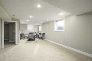 Game room featuring light carpet, healthy amount of natural light, and recessed lighting