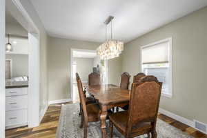 Dining area with a chandelier and light wood-style floors