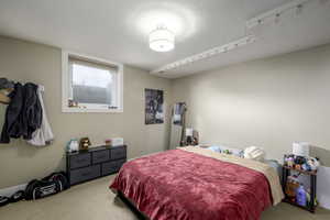 Bedroom featuring carpet and a textured ceiling