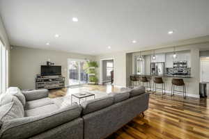 Living area with wood-type flooring and recessed lighting