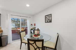 Dining space featuring light tile patterned flooring and recessed lighting