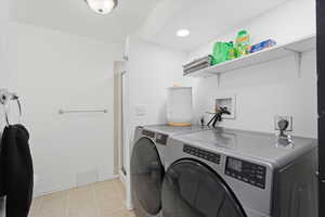 Laundry room featuring washing machine and clothes dryer and recessed lighting