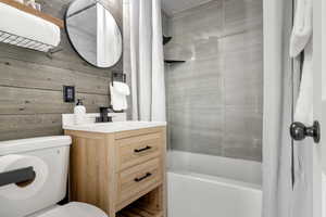Bathroom with shower / bathtub combination with curtain and vanity