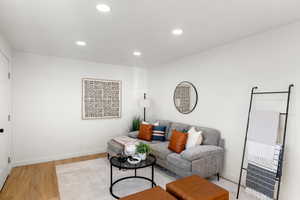 Living room featuring wood finished floors and recessed lighting