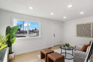 Sitting room featuring light wood-style flooring and recessed lighting