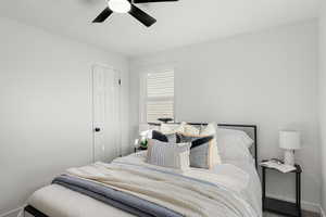 Bedroom with ceiling fan and baseboards