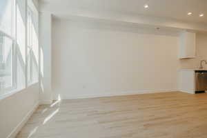 Unfurnished living room with light wood finished floors and recessed lighting