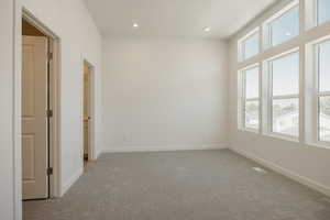 Unfurnished room featuring light carpet and recessed lighting