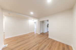 Unfurnished room with light wood-style floors and recessed lighting