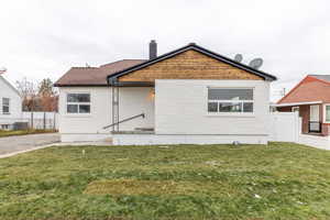 Rear view of house with a chimney and a patio area