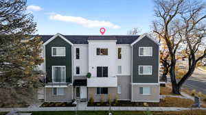 View of front of house with a shingled roof