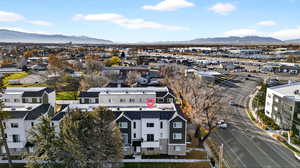 Aerial view of property's location with a mountainous background and nearby suburban area