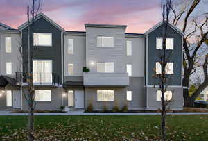 Contemporary home with a yard and a balcony