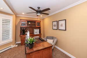 Office area with dark colored carpet, a ceiling fan, crown molding, and recessed lighting