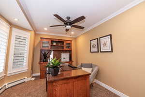Home office featuring a baseboard radiator, dark colored carpet, a ceiling fan, ornamental molding, and recessed lighting