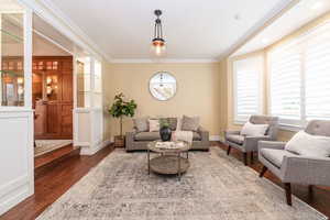 Living room featuring crown molding and wood finished floors