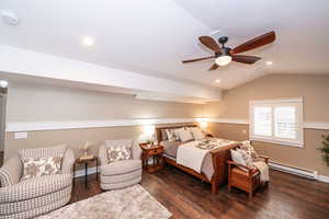 Bedroom featuring baseboard heating, lofted ceiling, dark wood-style flooring, a ceiling fan, and recessed lighting