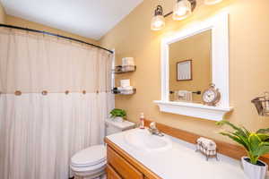 **CREDIT AVAILABLE FOR REMODEL** Full bathroom with a shower with shower curtain and vanity