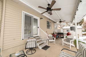 View of patio with a ceiling fan, an outdoor structure, and an outdoor living space