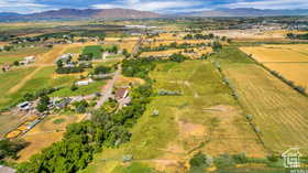 Aerial view of property's location with rural landscape and a mountainous background