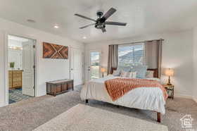 Bedroom featuring carpet flooring, access to exterior, a ceiling fan, ensuite bathroom, and recessed lighting