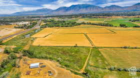 Aerial view of sparsely populated area with mountains and abundant farmland