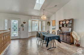 Dining room with lofted ceiling and a skylight