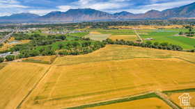 Aerial view of sparsely populated area featuring a mountain backdrop and extensive farmland