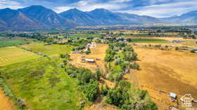 View of rural area featuring extensive farmland and a mountain backdrop