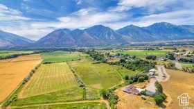 Overview of rural landscape featuring a mountain backdrop and extensive farmland