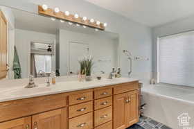 Full bathroom with double vanity and a garden tub