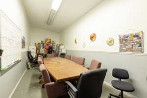 Dining area with lofted ceiling and baseboards