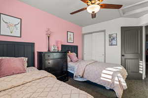 Carpeted bedroom featuring a closet and a ceiling fan